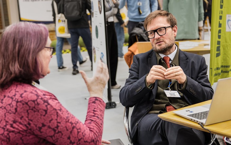 Exhibitor talking to visitors