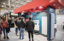 Visitors looking at Trade Village stand