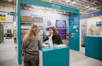 Visitors looking at Trade Village stand